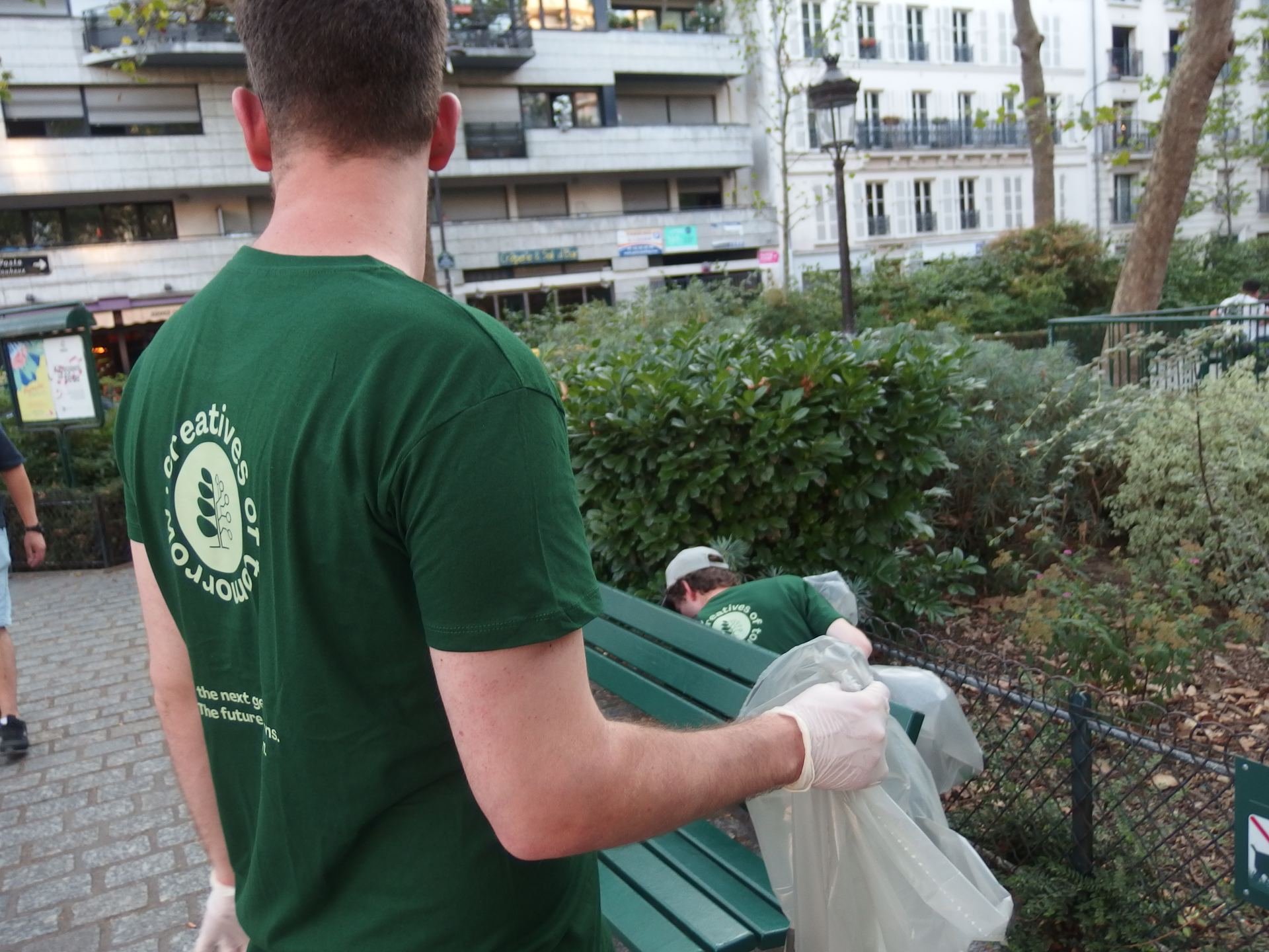 Creatives of Tomorrow volunteers bagging litter in a Paris park