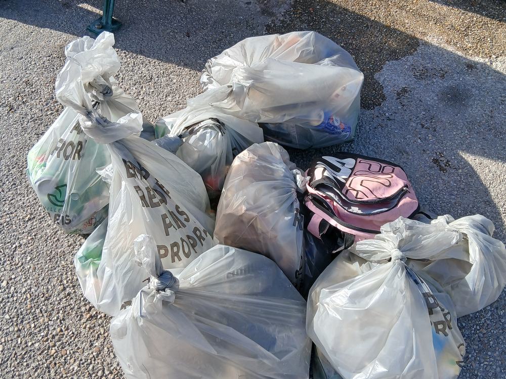 A pile of full bags of litter collected during a cleanup
