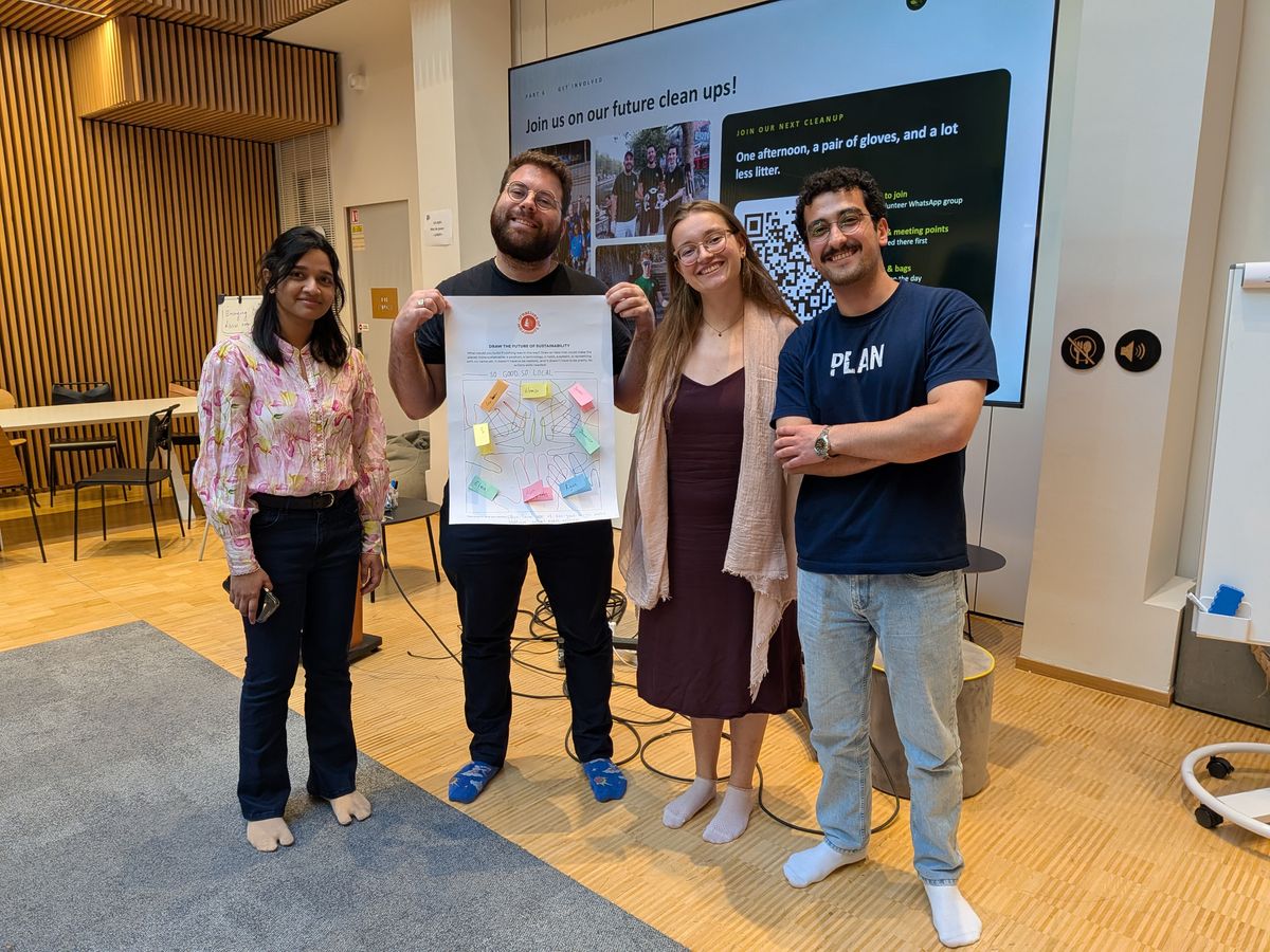 Students at a Creatives of Tomorrow university workshop holding up the poster they designed